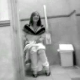 Some friends video record their girlfriend using a public restroom at a subway station.